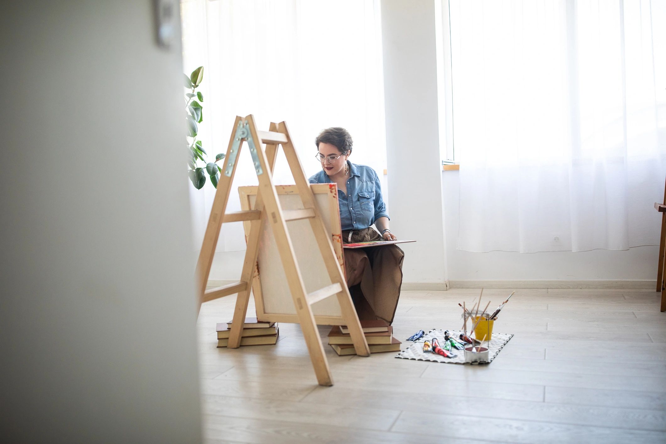 Artist painting on canvas in a studio