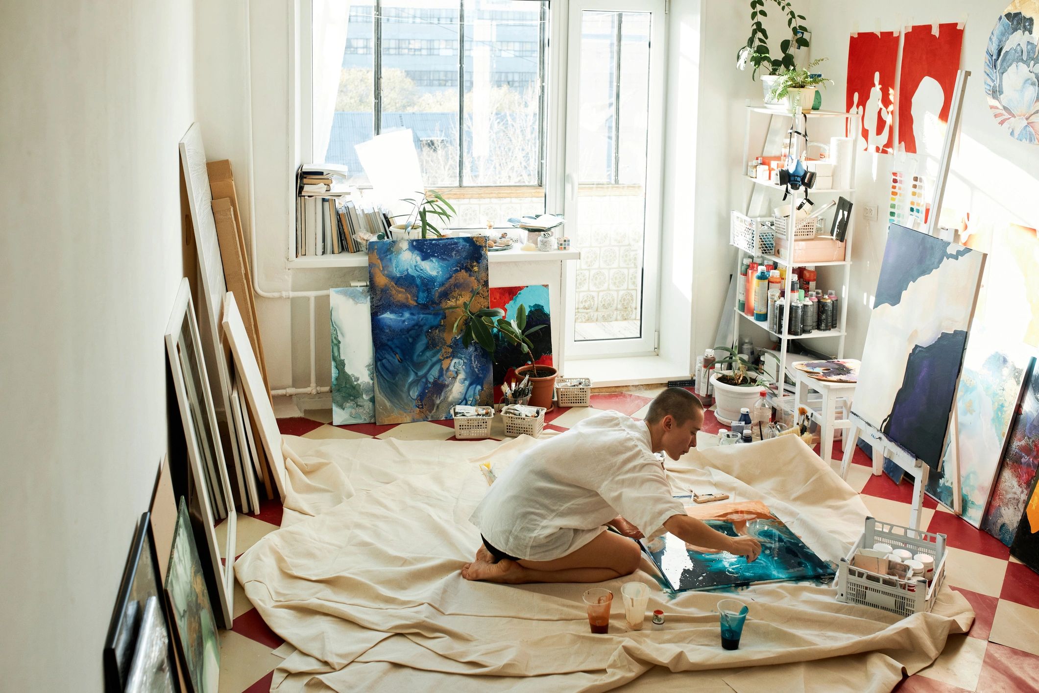 Artist working in a studio on a watercolor-inspired artwork